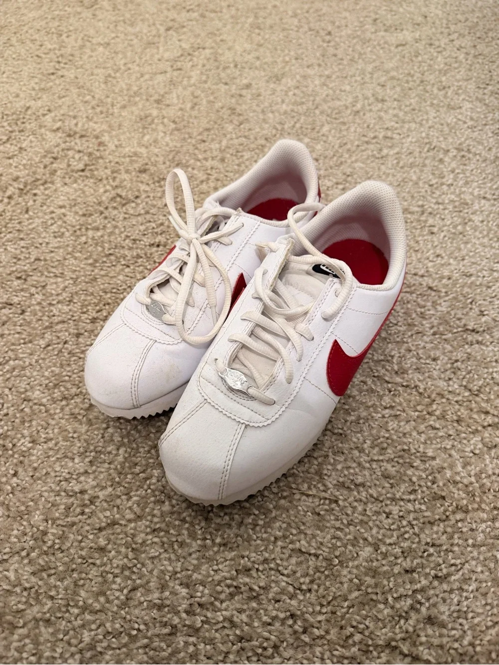 Nike White Sneakers with Red Swoosh and Blue Midsole Stripe